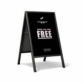 Black a-frame sign with white text inviting people to join for free on a white background