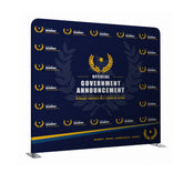 Navy blue backdrop with gold laurel wreath and text for official government announcement