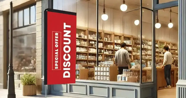 Portable red promotional banner outside a shopfront advertising a special offer discount
