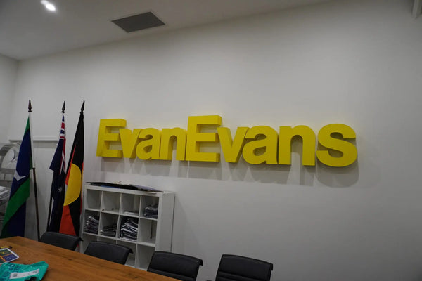 Evan Evans boardroom with backlit logo signage and Australian flags