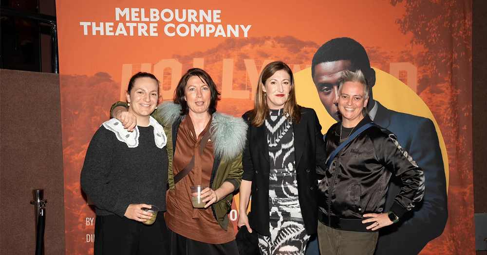Guests standing in front of a custom Melbourne Theatre Company media wall event backdrop