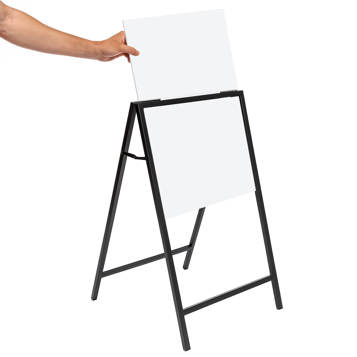 Male hand inserting a blank white corflute panel into a black metal A-frame sign holder on a clean white background