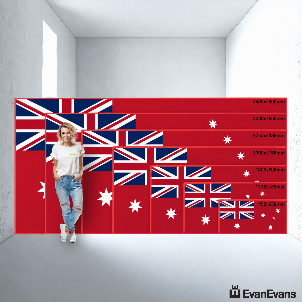 A person stands in a room in front of a large wall mural showing the Australian flag with multiple size options labeled on the right. The mural is red with white and blue stars and Union Jack elements.