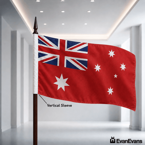 An Australian flag mounted on a flagpole, shown waving in a bright modern indoor hallway. The image includes a text label pointing to the white vertical sleeve on the pole and a watermark in the bottom right reading EvanEvans.
