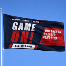 A navy blue and red promotional banner with white text reading 'GAME ON!' and 'REGISTER NOW' is attached to a flagpole against a clear blue sky.