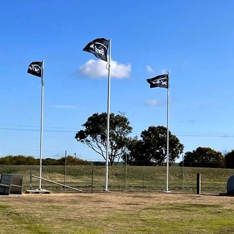 Three Gorst Rural Custom Flag on a field