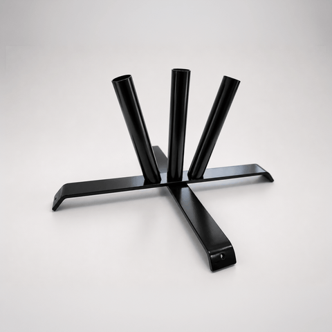 A black metal table base with three vertical cylindrical legs and a wide cross-shaped support frame, photographed on a clean light gray studio background.