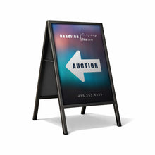 Outdoor sign with 'Auction' arrow pointing left on a white background