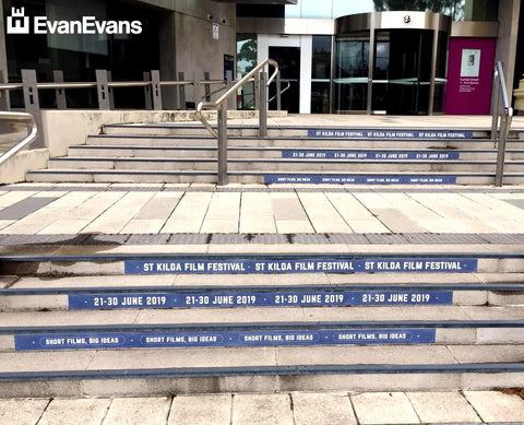 Creative step branding for the St Kilda Film Festival highlights event dates and themes, transforming the staircase into an eye-catching promotional platform.