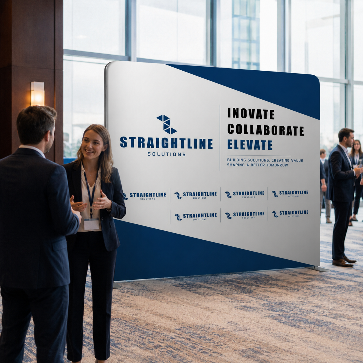Two people shaking hands in front of a Straightline Solutions display at an event.