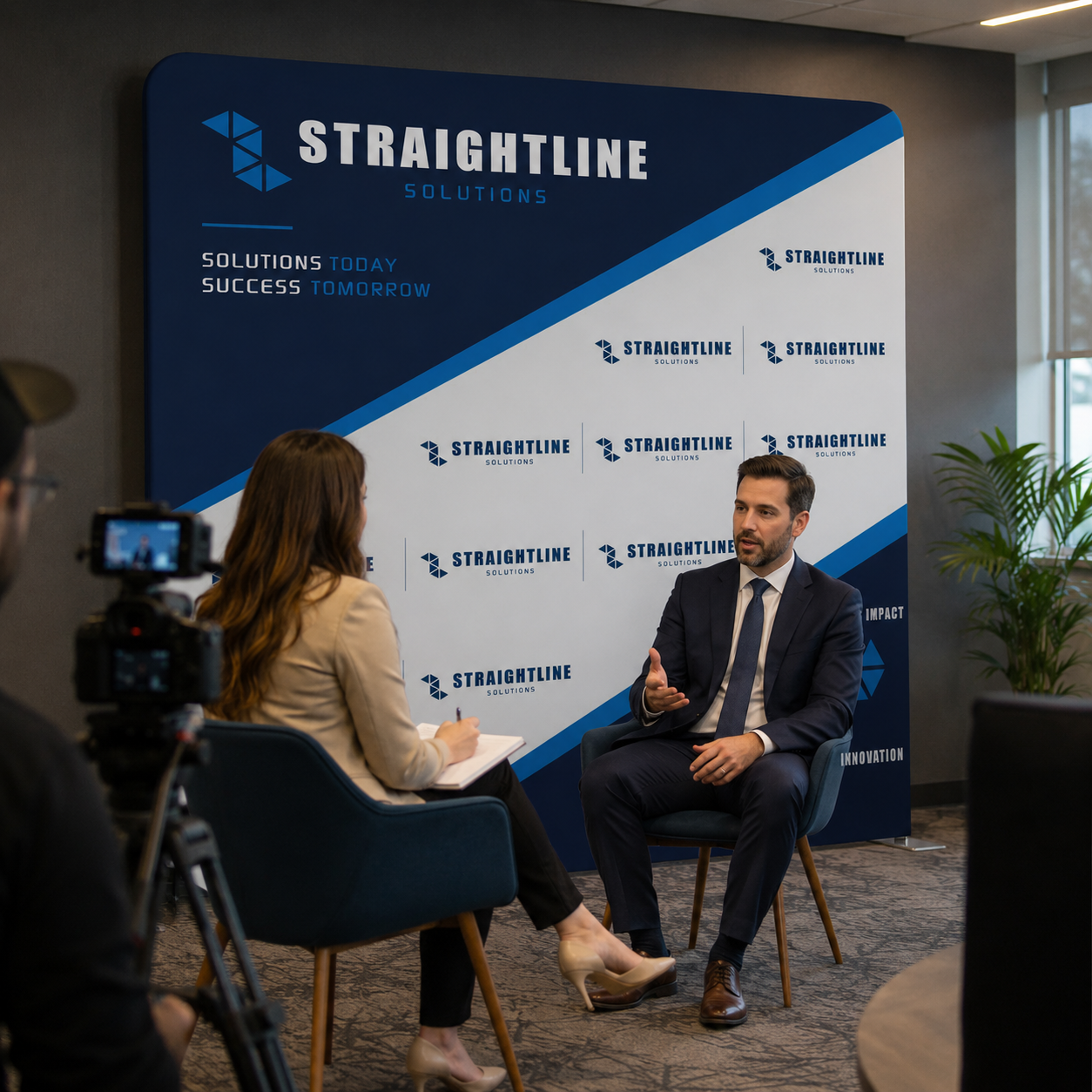 Two people in a discussion with a Straightline Solutions backdrop