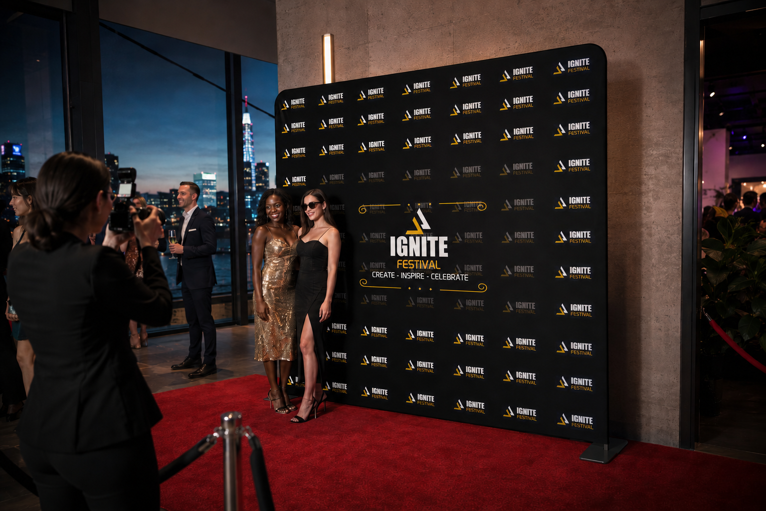 People on a red carpet at an event with a branded backdrop