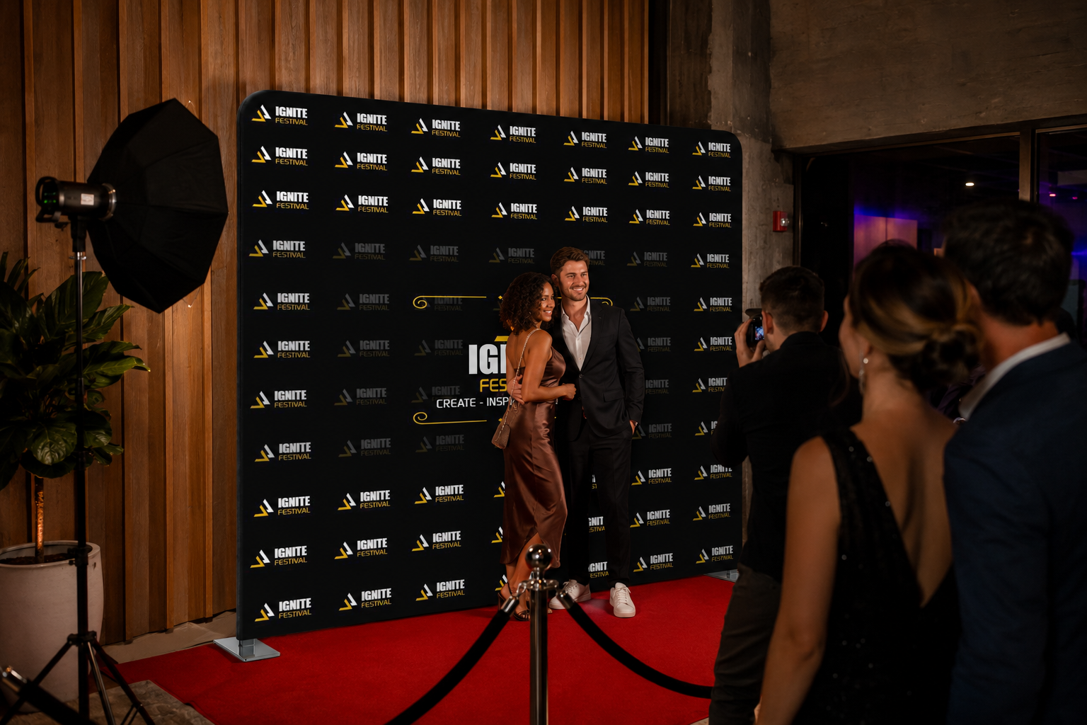 People on a red carpet event with a branded backdrop