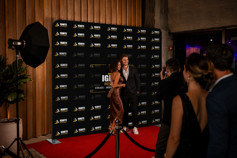 People on a red carpet event with a branded backdrop