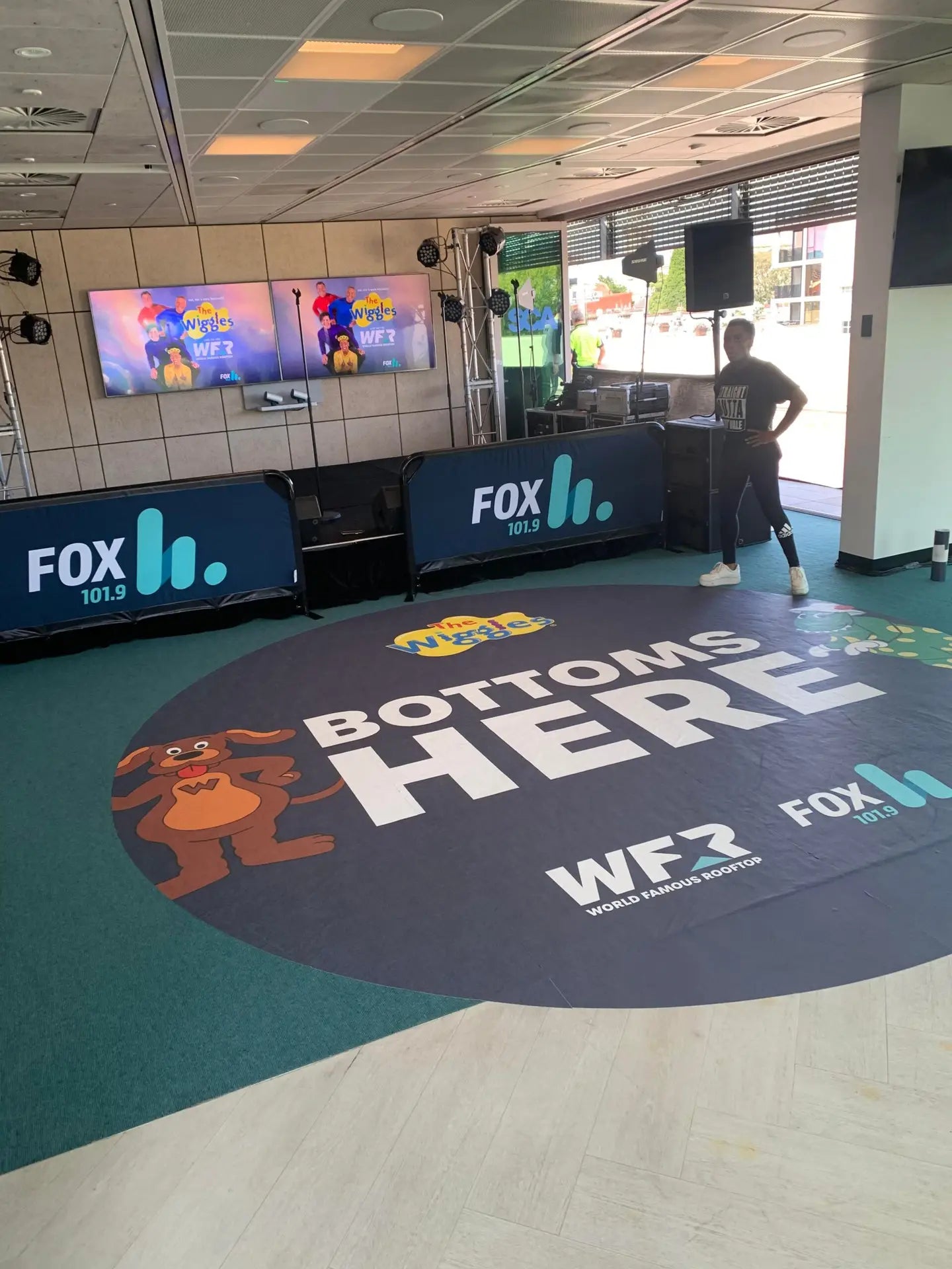 Custom indoor floor graphics at the FOX FM World Famous Rooftop event, featuring playful designs and branding, enhance the atmosphere and create engaging photo opportunities.
