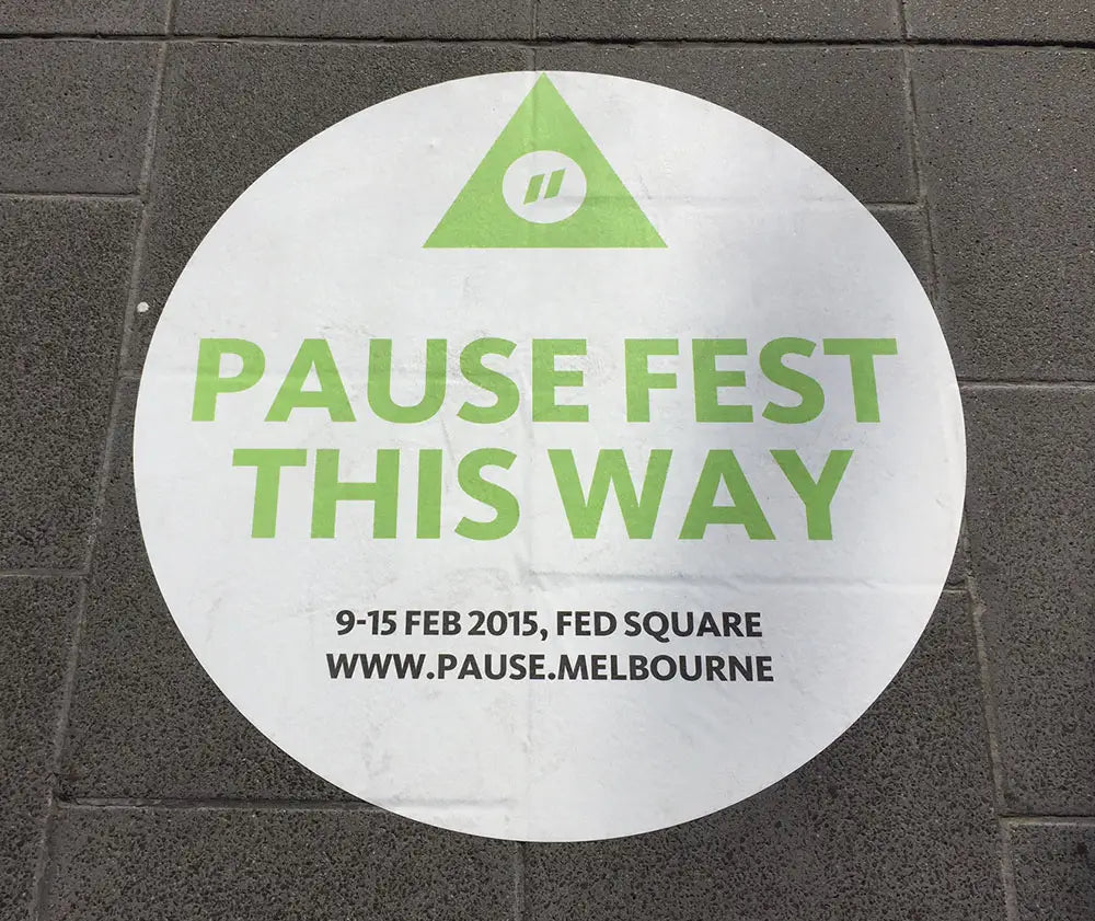 Circular floor decal for Pause Fest 2015 directs attendees with bold typography and a clean design, merging functionality with professional branding.