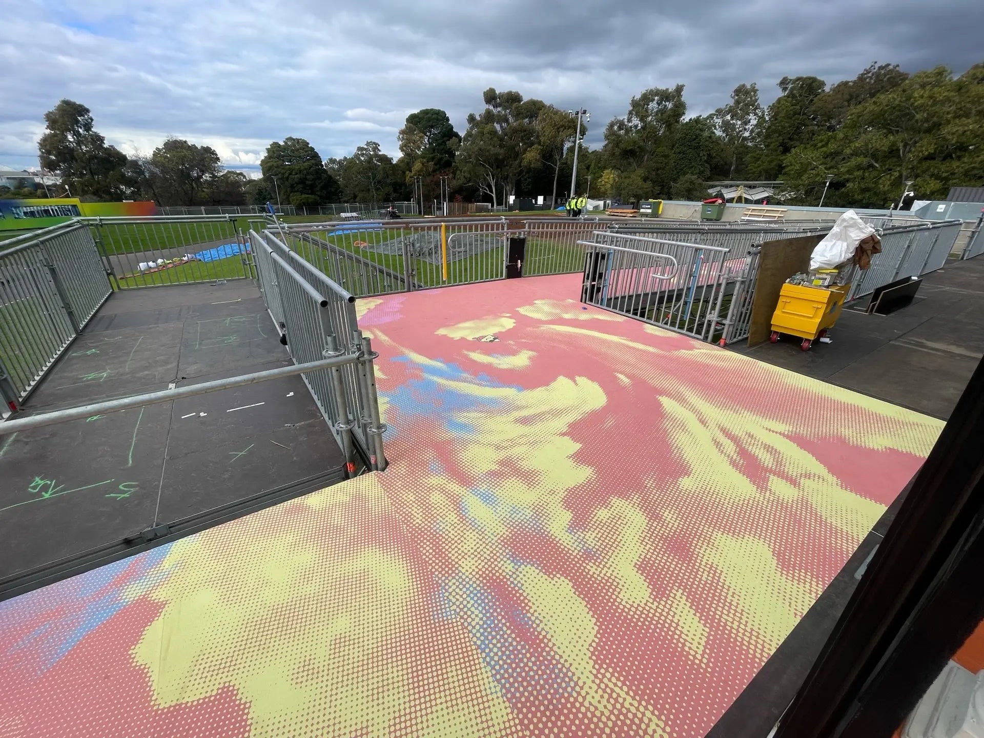 Unique flooring with pastel gradient designs adds personality to an outdoor event space, demonstrating the versatility of temporary flooring graphics for branding and aesthetics.