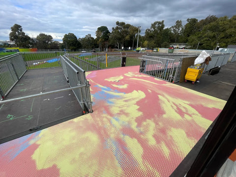 Unique flooring with pastel gradient designs adds personality to an outdoor event space, demonstrating the versatility of temporary flooring graphics for branding and aesthetics.