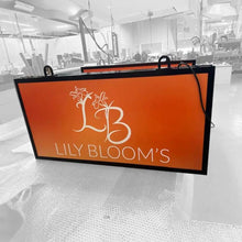 backlit signage lily blooms